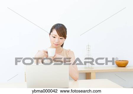 Attractive young girl working with laptop View Large Photo Image Stock Image - Attractive young girl working with laptop. Fotosearch