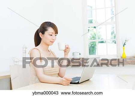 Attractive young girl working with laptop View Large Photo Image Stock Image - Attractive young girl working with laptop. Fotosearch