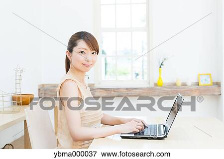 Attractive young girl working with laptop View Large Photo Image Stock Photo - Attractive young girl working with laptop. Fotosearch