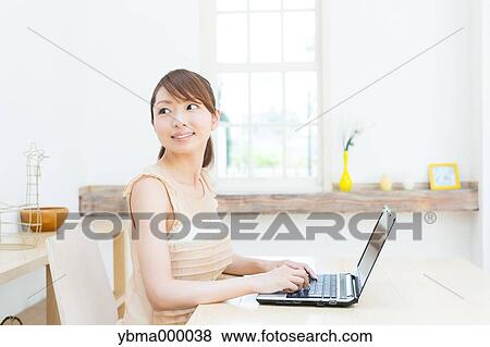 Stock Photo - Attractive young girl working with laptop. Fotosearch