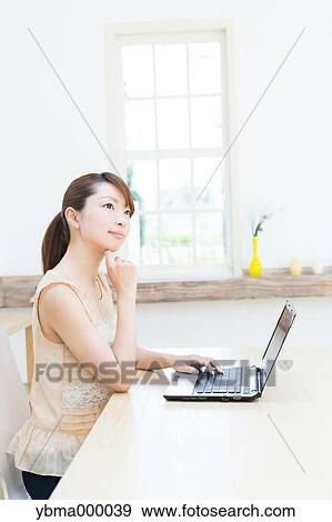 Stock Photo - Attractive young girl working with laptop. Fotosearch