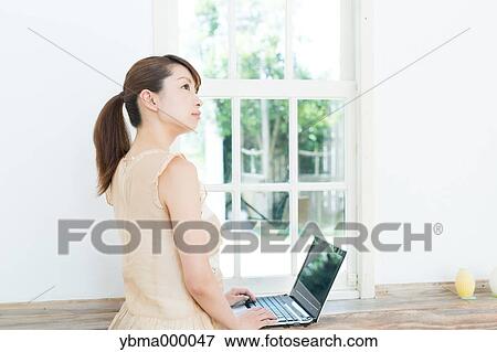 Attractive young girl working with laptop View Large Photo Image Stock Photo - Attractive young girl working with laptop. Fotosearch