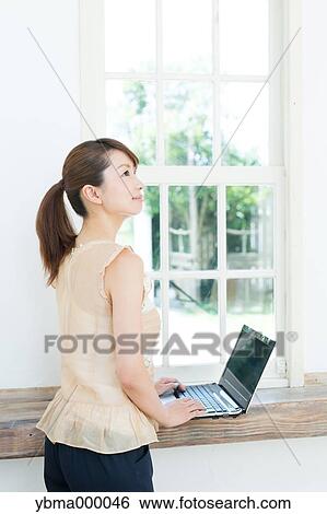 Attractive young girl working with laptop View Large Photo Image Stock Photograph - Attractive young girl working with laptop. Fotosearch
