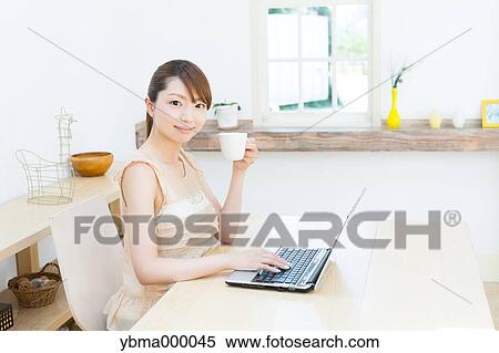 Attractive young girl working with laptop View Large Photo Image Stock Photography - Attractive young girl working with laptop. Fotosearch