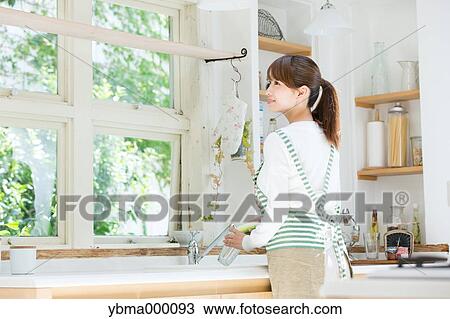 Stock Image - Attractive young housewife. Fotosearch