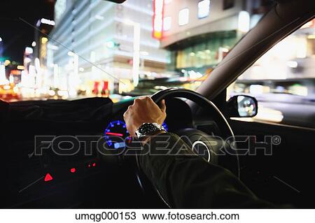 Japanese man driving his car in the Tokyo streets View Large Photo Image Stock Image - Japanese man driving his car in the Tokyo streets. Fotosearch