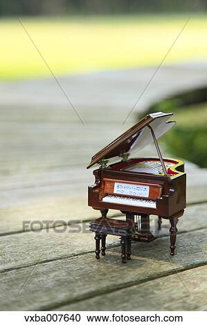 Stock Image - Miniature piano in nature. Fotosearch