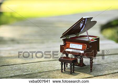 Miniature piano in nature View Large Photo Image Stock Image - Miniature piano in nature. Fotosearch