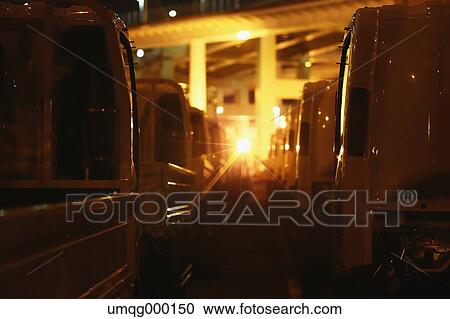 Stock Image - Vehicles in a line at night in a Tokyo street. Fotosearch