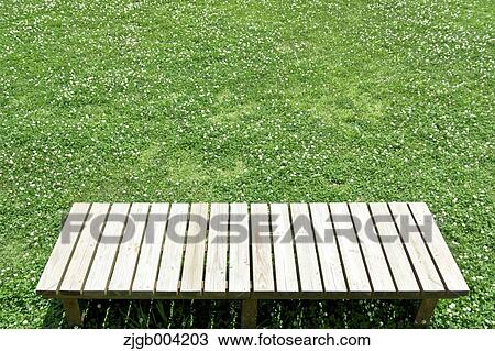 Wooden bench on lawn View Large Photo Image Stock Image - Wooden bench on lawn. Fotosearch