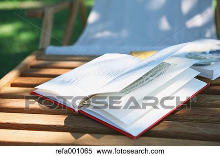 Book on deck chair in a city park View Large Photo Image Stock Photography - Book on deck chair in a city park. Fotosearch