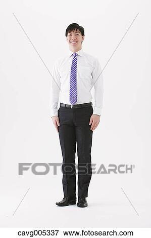 Businessman standing looking at camera View Large Photo Image Stock Photo - Businessman standing looking at camera. Fotosearch