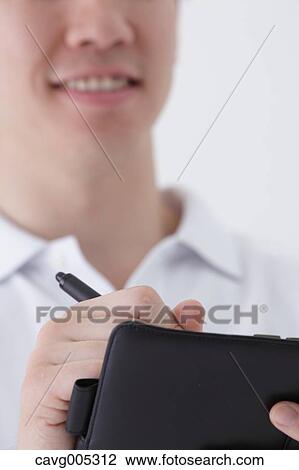 Businessman with notebook View Large Photo Image Stock Image - Businessman with notebook. Fotosearch