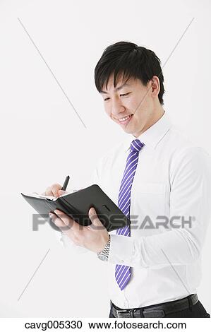 Businessman with notebook View Large Photo Image Stock Image - Businessman with notebook. Fotosearch