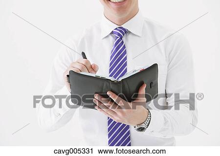 Businessman with notebook View Large Photo Image Stock Image - Businessman with notebook. Fotosearch