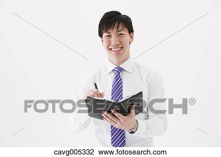 Stock Image - Businessman with notebook. Fotosearch