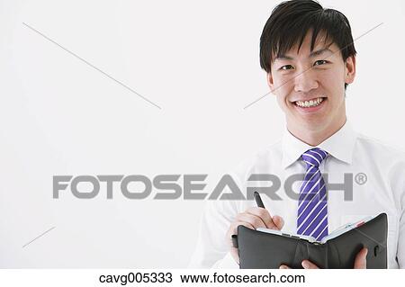 Stock Image - Businessman with notebook. Fotosearch