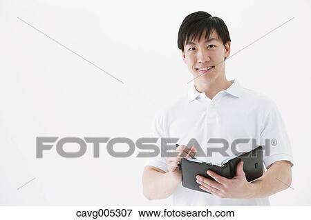 Businessman with notebook View Large Photo Image Stock Photo - Businessman with notebook. Fotosearch