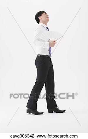 Businessman with paper fan View Large Photo Image Stock Image - Businessman with paper fan. Fotosearch