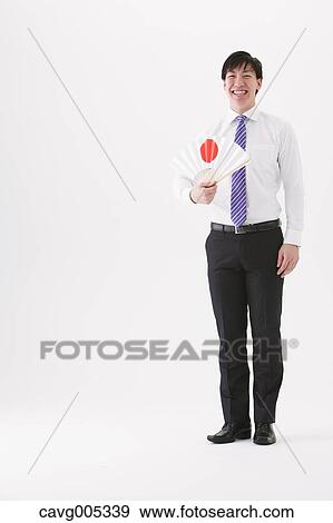 Businessman with paper fan View Large Photo Image Stock Photo - Businessman with paper fan. Fotosearch