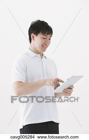 Picture - Businessman with tablet. Fotosearch
