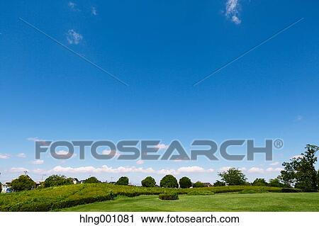 Stock Image - City park and blue sky. Fotosearch