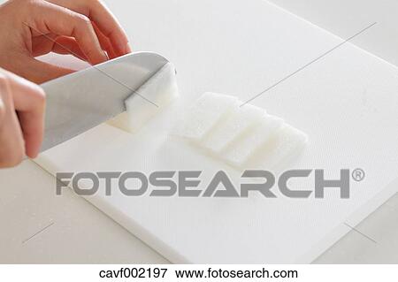 Stock Photo - Close up of woman's hands cutting radish with a kitchen knife. Fotosearch
