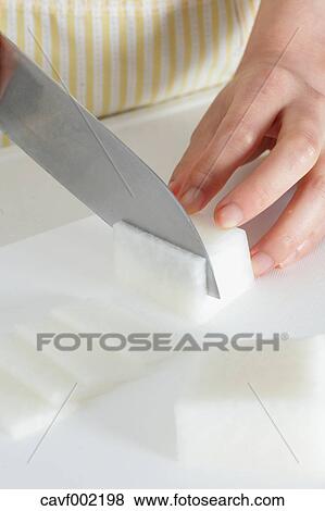 Close up of woman's hands cutting radish with a kitchen knife View Large Photo Image Stock Photo - Close up of woman's hands cutting radish with a kitchen knife. Fotosearch