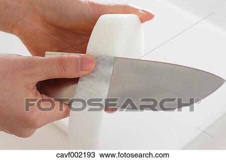 Close up of woman's hands peeling radish with a kitchen knife View Large Photo Image Stock Image - Close up of woman's hands peeling radish with a kitchen knife. Fotosearch