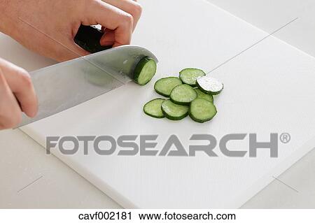 Close up of woman's hands slicing cucumbers with a kitchen knife View Large Photo Image Stock Image - Close up of woman's hands slicing cucumbers with a kitchen knife. Fotosearch