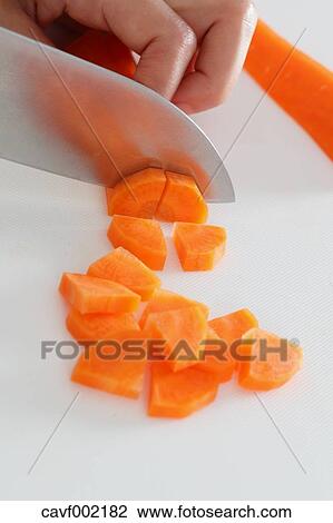 Close up of woman's hands slicing carrots with a kitchen knife View Large Photo Image Stock Image - Close up of woman's hands slicing carrots with a kitchen knife. Fotosearch