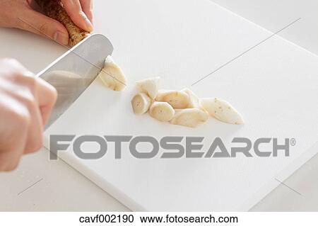 Close up of woman's hands slicing burdocks with a kitchen knife View Large Photo Image Stock Image - Close up of woman's hands slicing burdocks with a kitchen knife. Fotosearch
