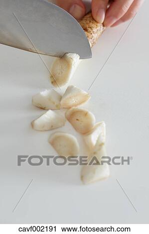 Close up of woman's hands slicing burdocks with a kitchen knife View Large Photo Image Stock Image - Close up of woman's hands slicing burdocks with a kitchen knife. Fotosearch