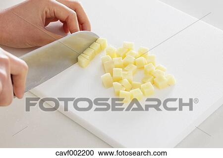 Close up of woman's hands slicing potatoes with a kitchen knife View Large Photo Image Stock Image - Close up of woman's hands slicing potatoes with a kitchen knife. Fotosearch