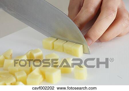 Close up of woman's hands slicing potatoes with a kitchen knife View Large Photo Image Stock Image - Close up of woman's hands slicing potatoes with a kitchen knife. Fotosearch