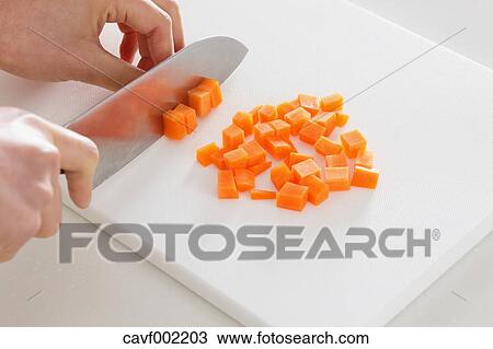 Close up of woman's hands slicing carrots with a kitchen knife View Large Photo Image Stock Image - Close up of woman's hands slicing carrots with a kitchen knife. Fotosearch