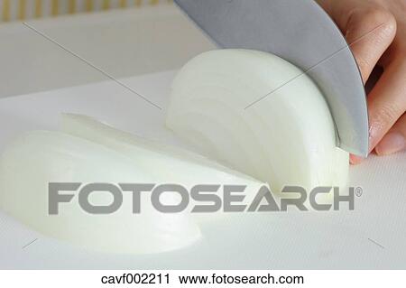 Close up of woman's hands slicing onions with a kitchen knife View Large Photo Image Stock Image - Close up of woman's hands slicing onions with a kitchen knife. Fotosearch