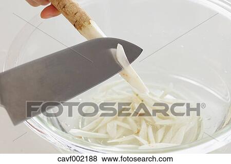Close up of woman's hands slicing burdocks with a kitchen knife View Large Photo Image Stock Photo - Close up of woman's hands slicing burdocks with a kitchen knife. Fotosearch