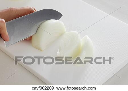 Close up of woman's hands slicing onions with a kitchen knife View Large Photo Image Stock Photo - Close up of woman's hands slicing onions with a kitchen knife. Fotosearch