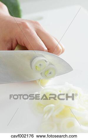 Close up of woman's hands slicing onions with a kitchen knife View Large Photo Image Stock Photograph - Close up of woman's hands slicing onions with a kitchen knife. Fotosearch