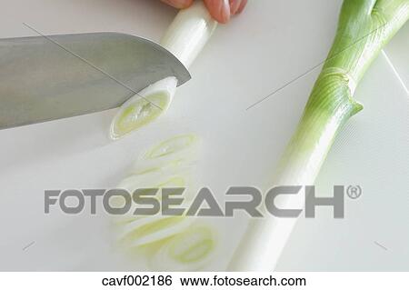 Close up of woman's hands slicing onions with a kitchen knife View Large Photo Image Stock Photograph - Close up of woman's hands slicing onions with a kitchen knife. Fotosearch