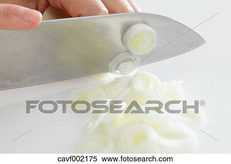 Close up of woman's hands slicing onions with a kitchen knife View Large Photo Image Stock Photography - Close up of woman's hands slicing onions with a kitchen knife. Fotosearch