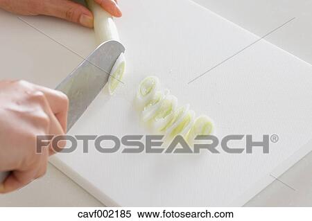 Close up of woman's hands slicing onions with a kitchen knife View Large Photo Image Stock Photography - Close up of woman's hands slicing onions with a kitchen knife. Fotosearch
