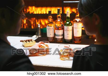 Couple drinking in a fashionable bar View Large Photo Image Stock Image - Couple drinking in a fashionable bar. Fotosearch
