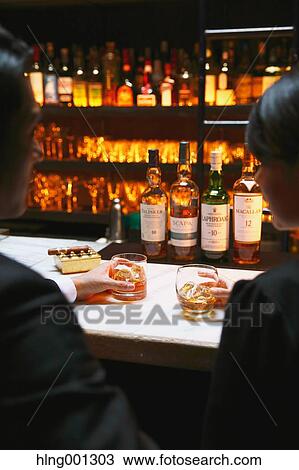 Couple drinking in a fashionable bar View Large Photo Image Stock Image - Couple drinking in a fashionable bar. Fotosearch