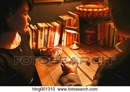 Stock Image - Couple drinking in a fashionable bar. Fotosearch