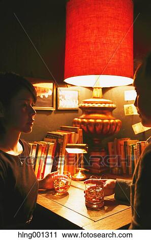 Stock Image - Couple drinking in a fashionable bar. Fotosearch