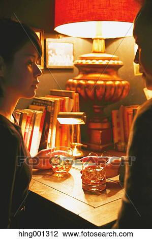 Couple drinking in a fashionable bar View Large Photo Image Stock Image - Couple drinking in a fashionable bar. Fotosearch