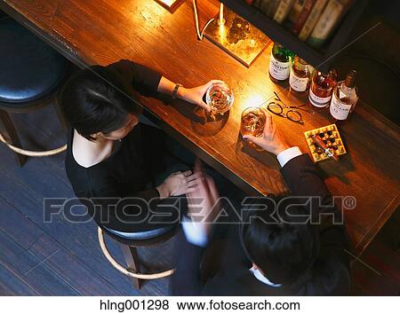 Couple drinking in a fashionable bar View Large Photo Image Stock Photo - Couple drinking in a fashionable bar. Fotosearch