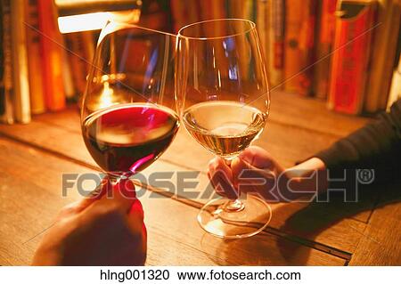 Couple toasting with wine in a fashionable bar View Large Photo Image Stock Image - Couple toasting with wine in a fashionable bar. Fotosearch